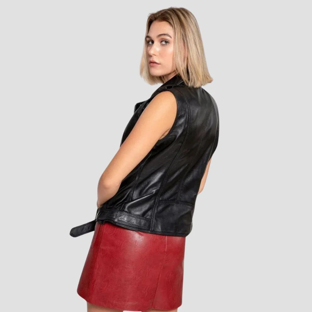 Rear three-quarter view of women’s black leather vest displaying smooth back panel, contour seams and buckled hem belt