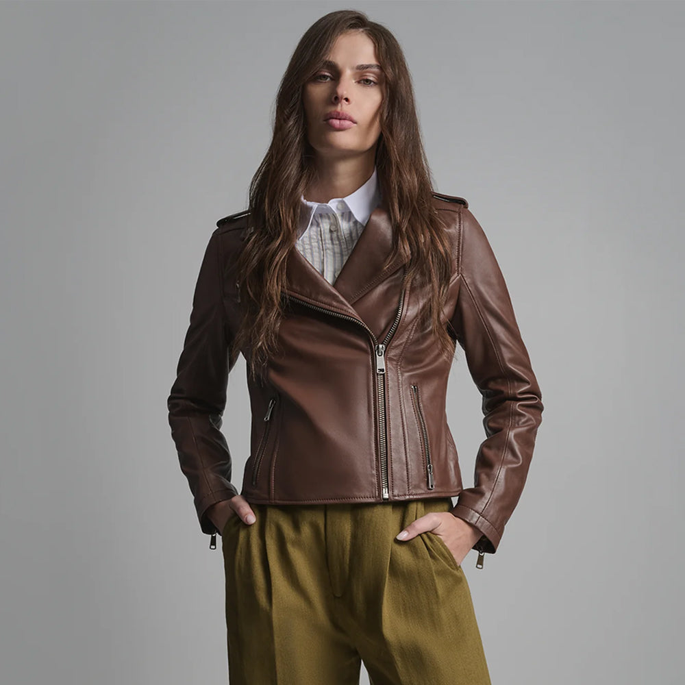 Front view of female model wearing a medium-brown asymmetrical leather biker jacket with closed zipper.