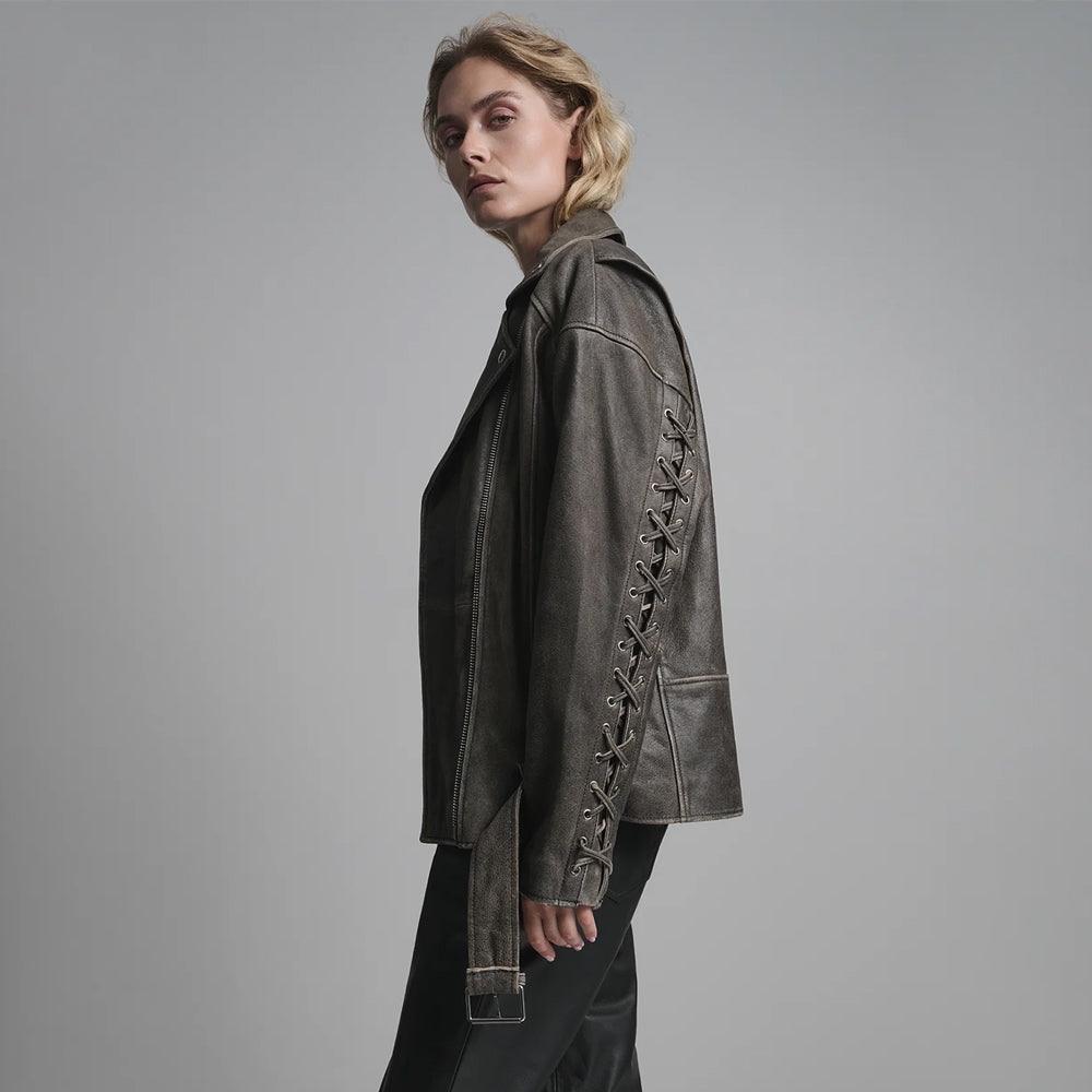 Side profile of women's vintage distressed leather jacket showing dropped shoulder fit and belt adjustment.
