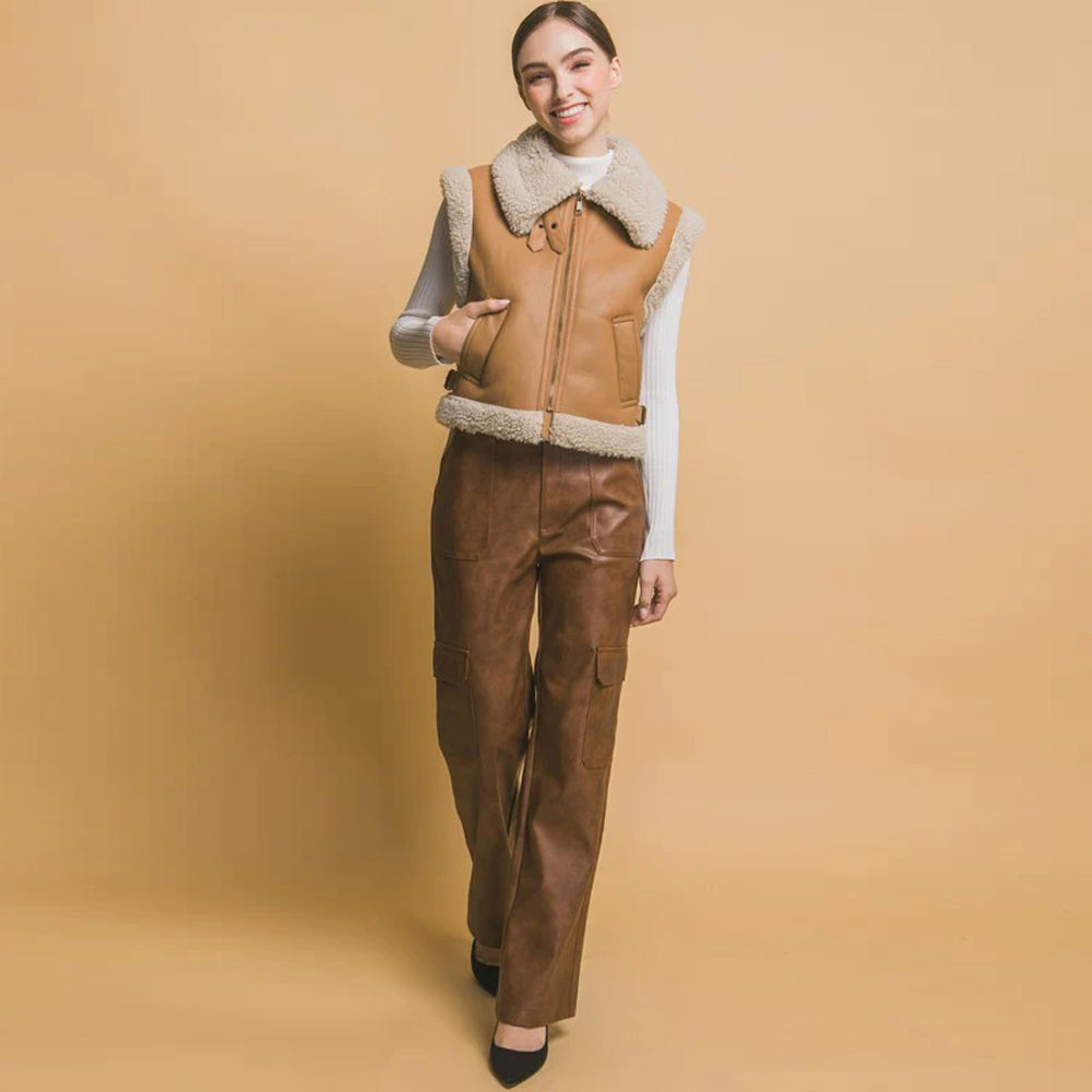 Women's tan shearling vest styled with matching leather pants, full body view