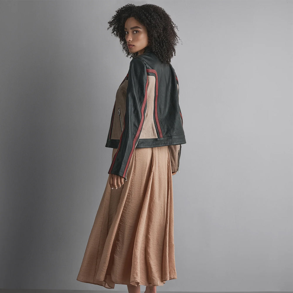 Rear three-quarter view of women’s striped leather racing jacket displaying clean black back and wrapped contrast paneling