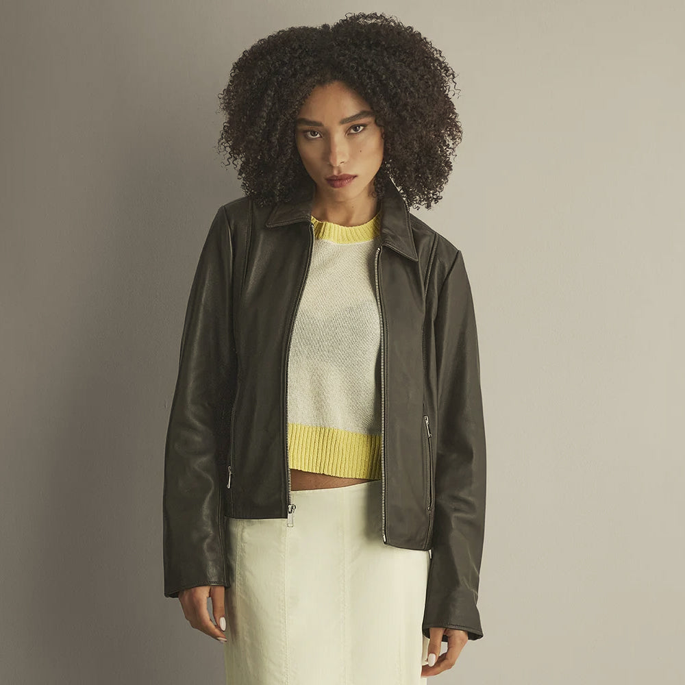 Women’s chocolate leather shacket worn open with a straight front zipper, classic collar and clean minimalist construction.