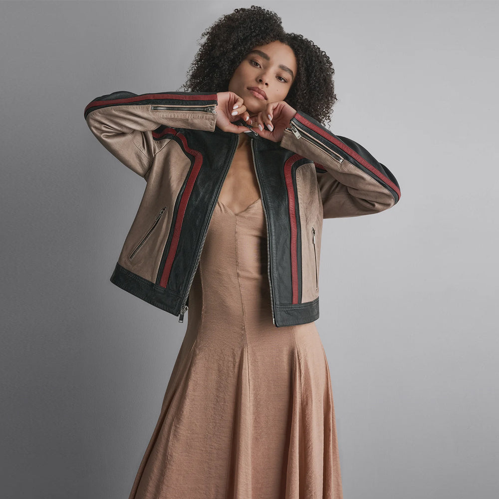 Close-up of adjustable zip cuffs, taupe sleeve inserts and burgundy piping-style bands on color-block leather jacket